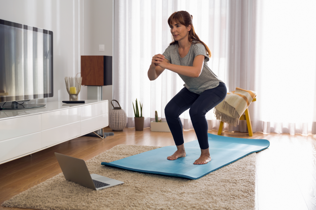 Woman working out in living room.